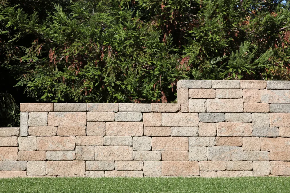 Stacked concrete block retaining wall terracing a landscaped yard in Asheville NC - The Western NC Concrete Company