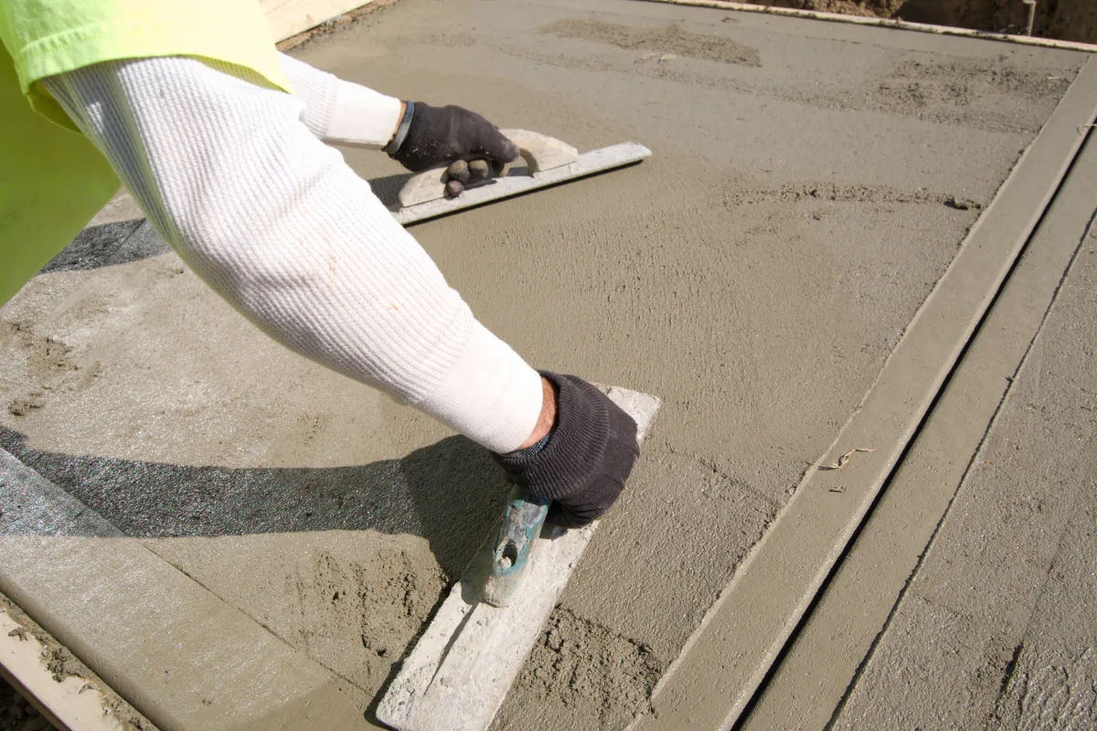 Crew hand-troweling a commercial concrete surface in Western NC - The Western NC Concrete Company