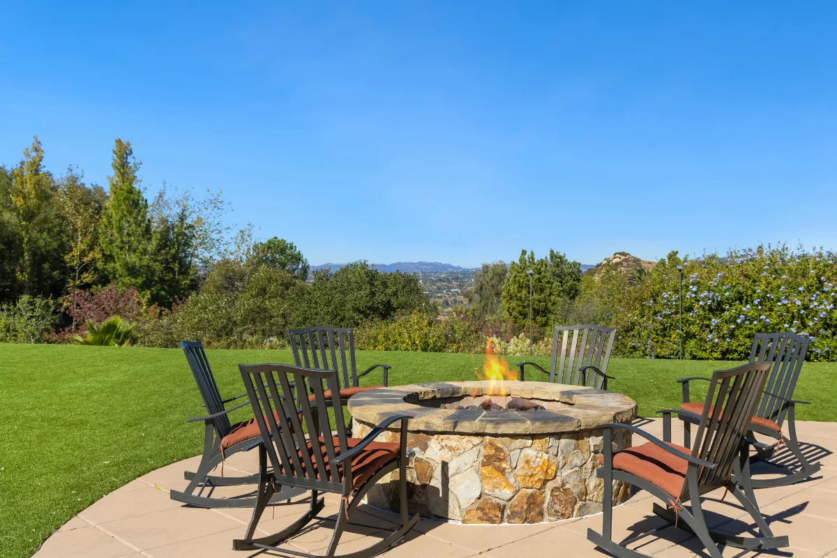Poured concrete patio built around a stone fire pit with seating in Western NC - The Western NC Concrete Company
