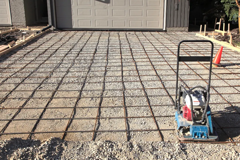 Rebar reinforcement and compacted base prep ahead of a driveway pour in Asheville NC - The Western NC Concrete Company