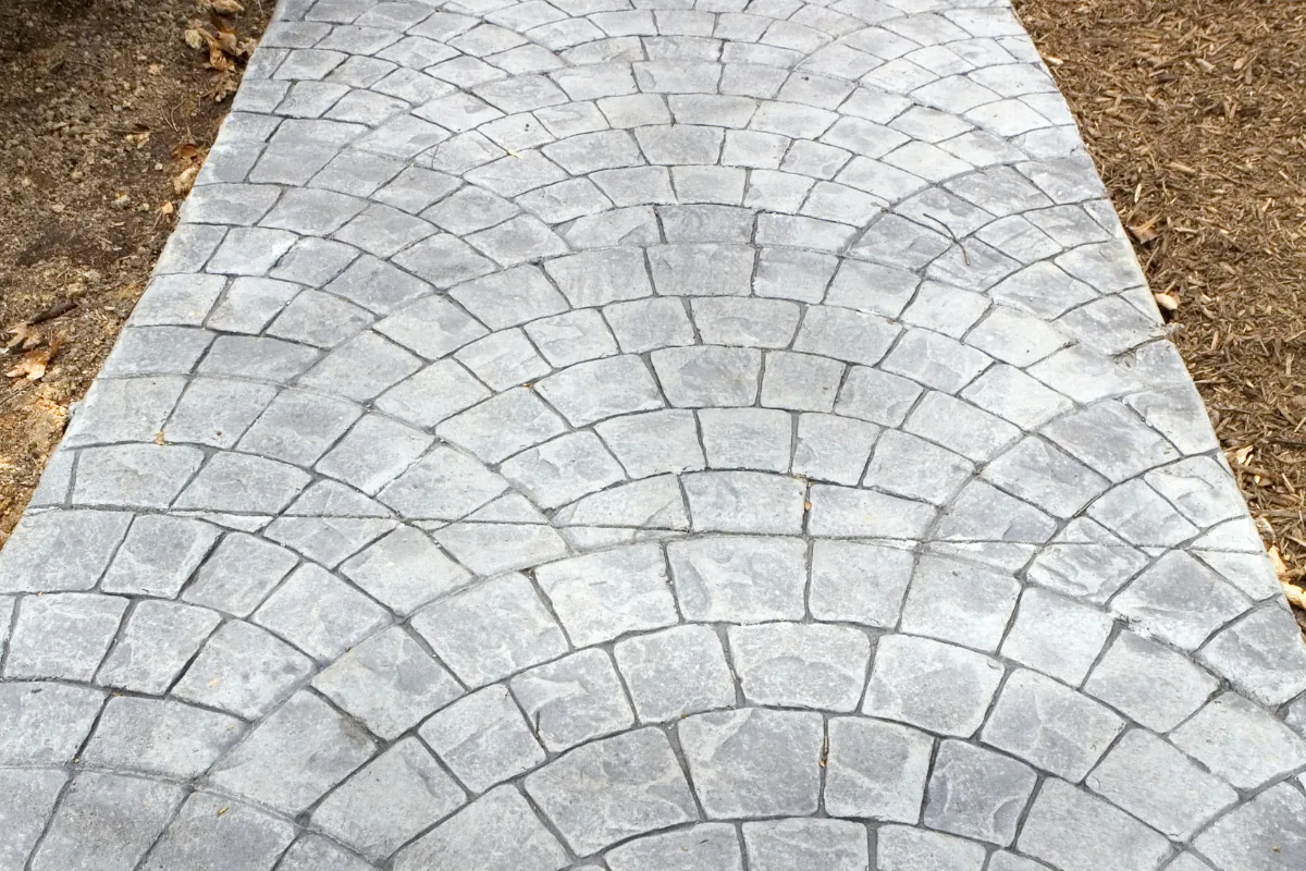 Cobblestone-pattern stamped concrete walkway running between beds in Western NC - The Western NC Concrete Company
